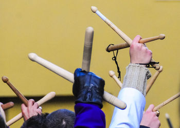 Cropped hands raised with wooden sticks during holy week