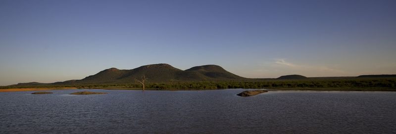 Scenic view of sea with mountain in background