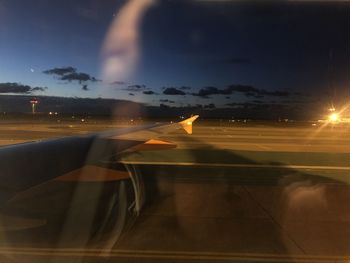 Blurred motion of airplane flying against sky during sunset