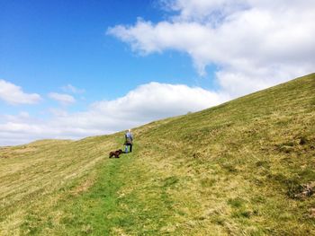 Full length of man standing on mountain landscape