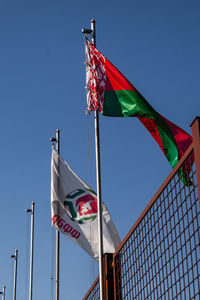 Low angle view of flag flags against sky