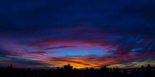 Silhouette buildings against sky during sunset