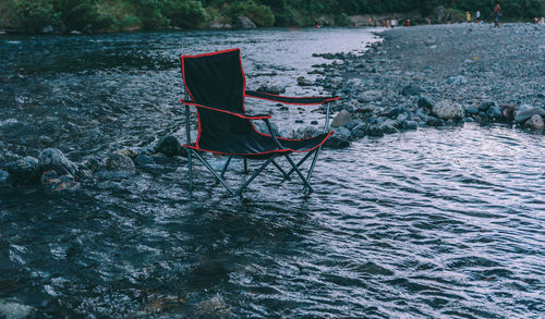 Camping chair in river at forest