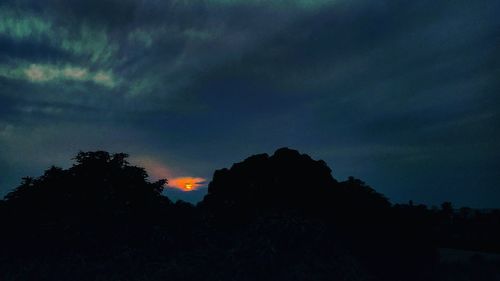 Low angle view of silhouette trees against sky at sunset
