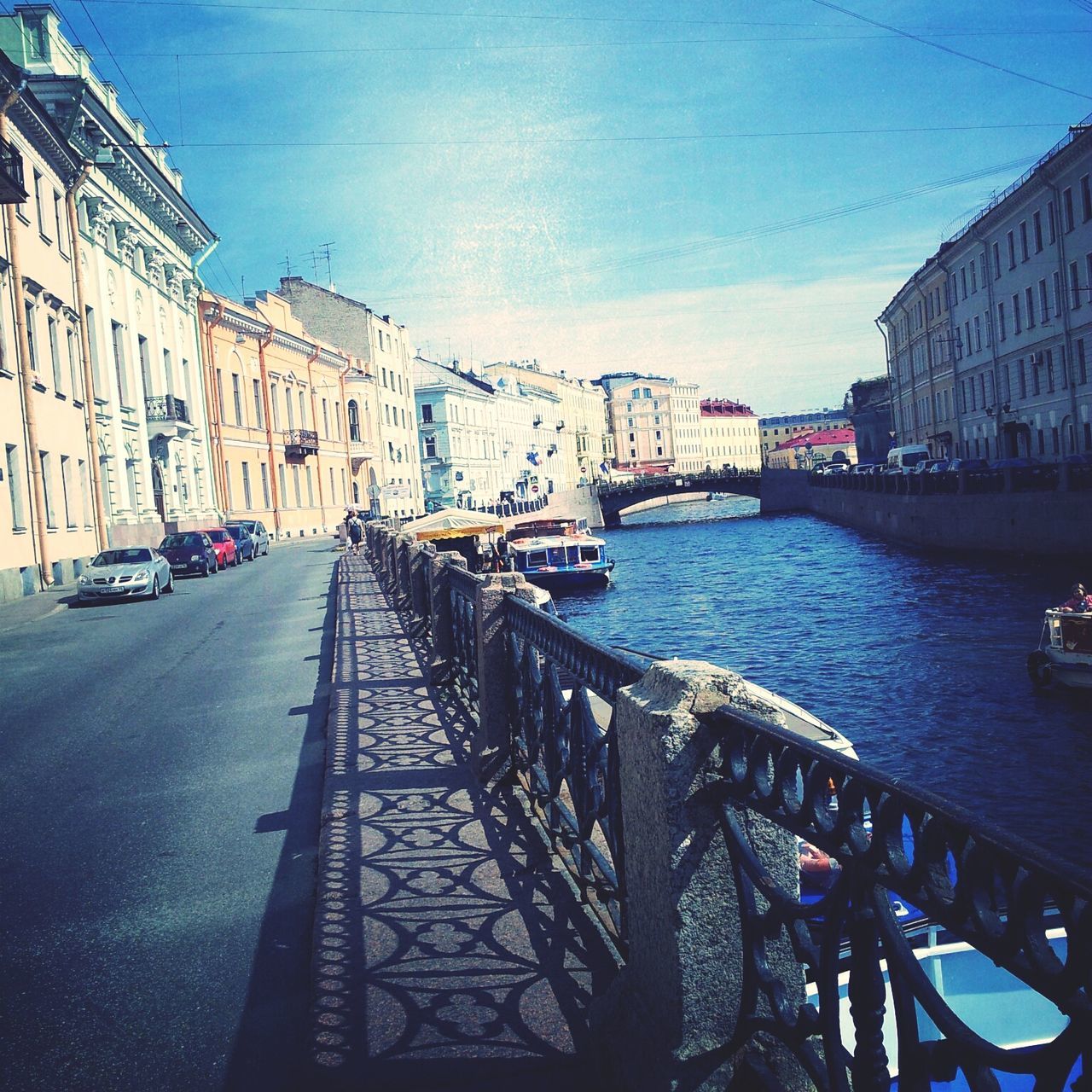 architecture, built structure, building exterior, transportation, mode of transport, water, city, car, the way forward, canal, sky, diminishing perspective, land vehicle, nautical vessel, vanishing point, incidental people, street, boat, residential structure, city life