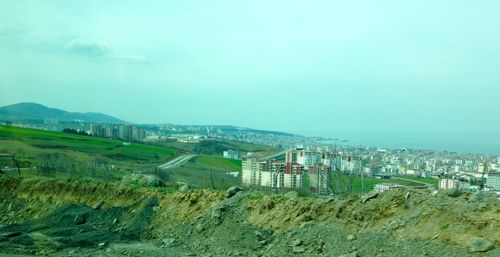 View of landscape against blue sky and clouds