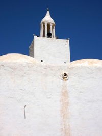 Low angle view of cross on building against sky