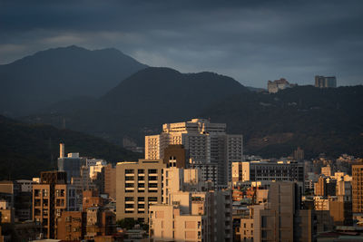 High angle view of buildings in city against sky at sunset