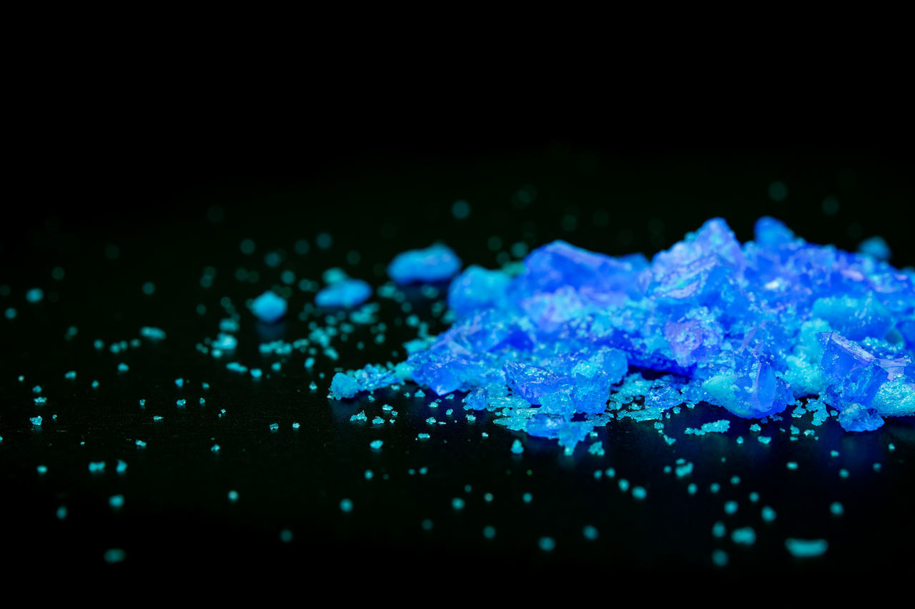 CLOSE-UP OF WATER DROPS ON ILLUMINATED GLASS