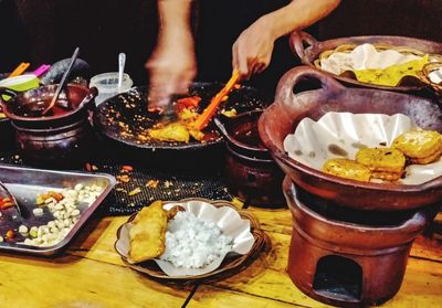 Person preparing food on table