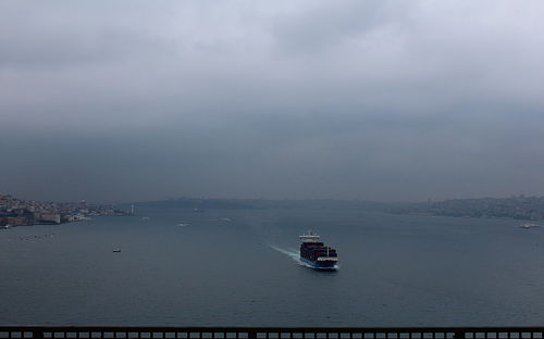 Boat sailing in sea against sky