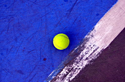 High angle view of yellow ball on blue background