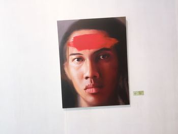 Close-up portrait of young woman against white background