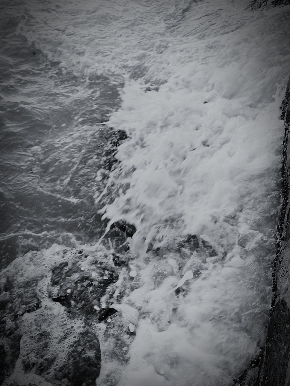 water, tranquility, nature, beauty in nature, tranquil scene, high angle view, scenics, sea, surf, wave, shore, beach, outdoors, day, idyllic, no people, non-urban scene, rock - object, motion, river