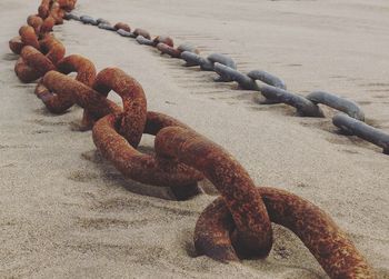 Close-up of rusty metal chain tied up