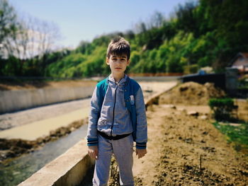 Portrait of boy standing outdoors