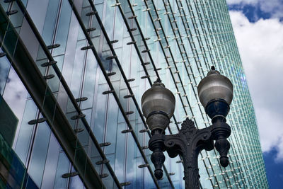 Low angle view of modern building against cloudy sky