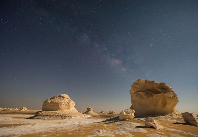 Scenic view of rocks and stars at night