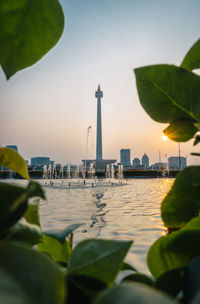 View of buildings at waterfront during sunset