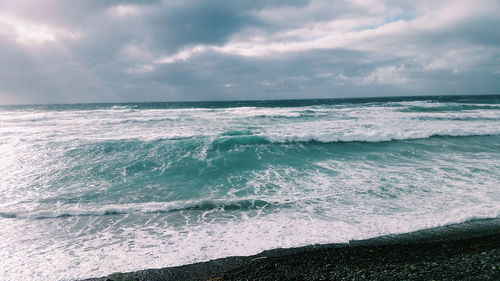 Scenic view of sea against dramatic sky