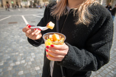 Midsection of woman holding ice cream