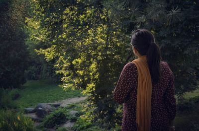 Rear view of woman standing in park