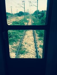 Railroad track seen through train window