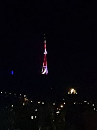 Low angle view of illuminated building against sky at night