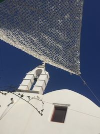 Low angle view of clothes drying on roof against sky