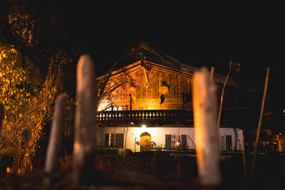 Illuminated building against sky at night