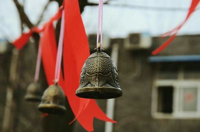 Close-up of red bell hanging outdoors