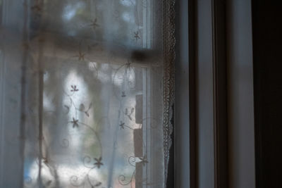 Close-up of glass window against wall