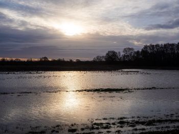 Scenic view of lake against sky during sunset
