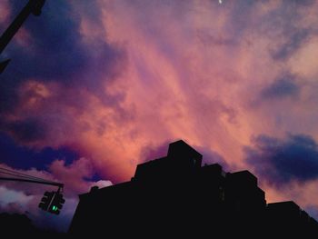 Low angle view of building against cloudy sky