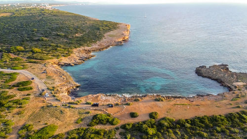 Aerial drone view of the mediterranean coast at sunrise in porto colom, majorca, balearic islands