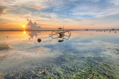 Scenic view of sea against sky at sunset