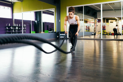 Young woman exercising in gym