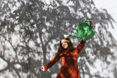 Portrait of a smiling young woman standing in snow