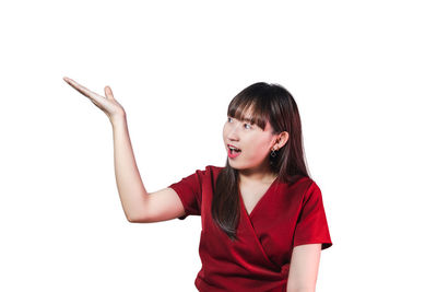 Young woman standing against white background