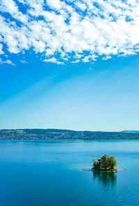 Scenic view of sea against blue sky