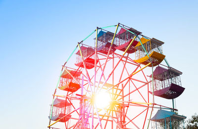 Low angle view of ferris wheel against clear sky