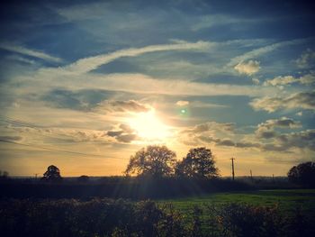 Scenic view of field against sky during sunset