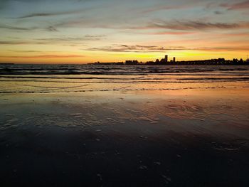 Scenic view of beach against sky during sunset