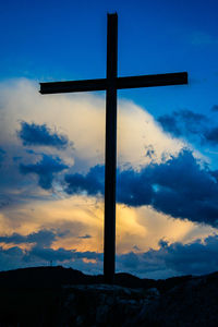 Low angle view of cross against sky during sunset