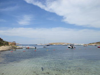 Sailboats on sea against sky