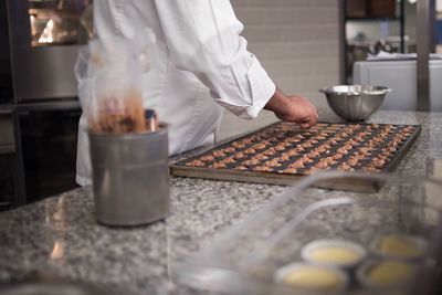 Close-up of person preparing food in kitchen