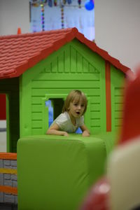 Portrait of cute girl playing in playhouse