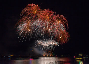 Low angle view of firework display at night