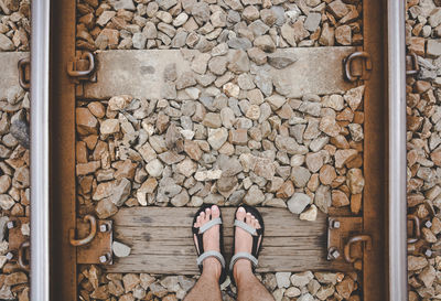 A man standing on the straight railroad or train tracks, the concept of journey travel, adventure 