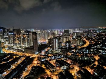 High angle view of illuminated cityscape against sky at night